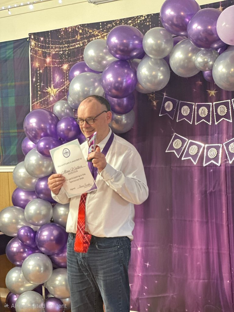 Man winning award at ENABLE event holding trophy & certificate for McFarlane Trust